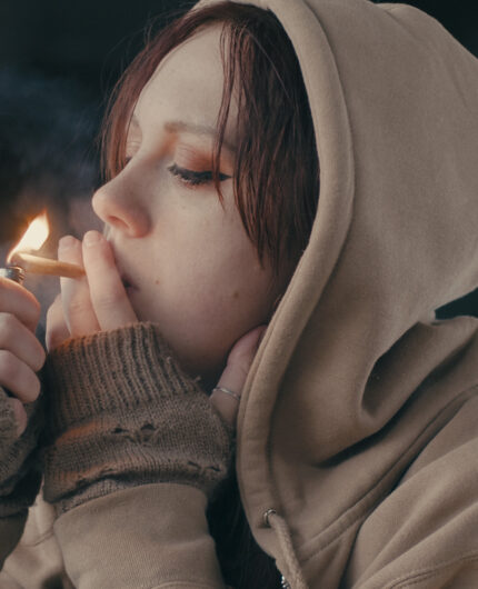 girl lighting up a foundry delta 8 pre-roll