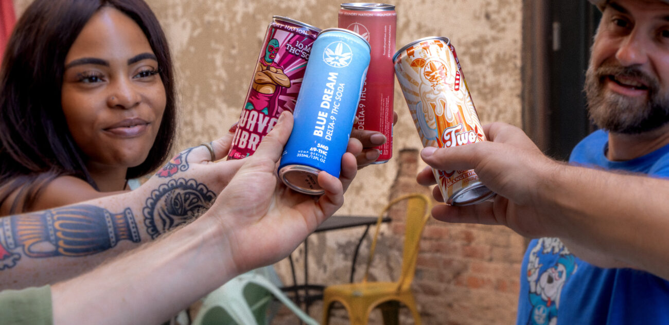 group of happy people cheersing with foundry sodas