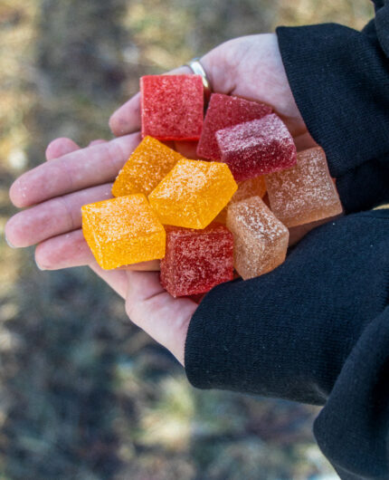 a handful of foundry gummies held with two hands