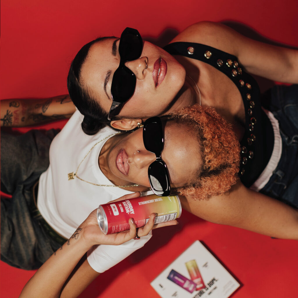 two people holding THC drinks